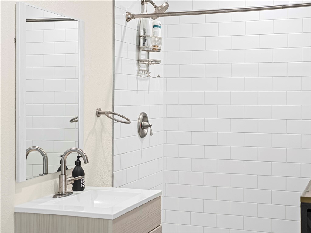555 East 3rd Street Long Beach, CA 90802 - Photo 12 of 19 a bathroom with a sink and a shower