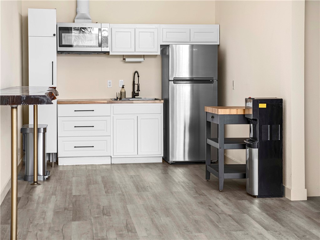 555 East 3rd Street Long Beach, CA 90802 - Photo 6 of 19 a kitchen with appliances cabinets and wooden floor