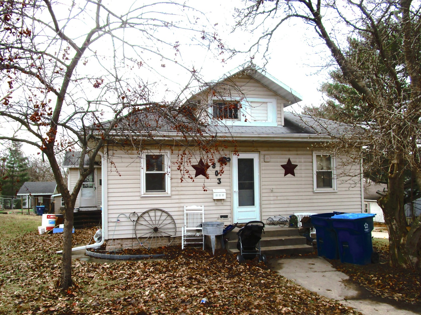 a front view of a house with sitting area