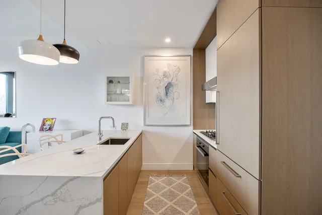a kitchen with a sink a counter space cabinets and appliances