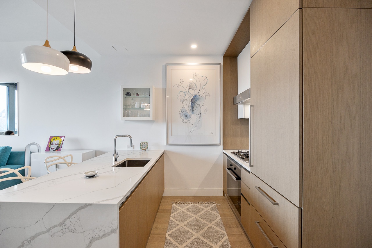 a kitchen with a sink a counter space cabinets and appliances