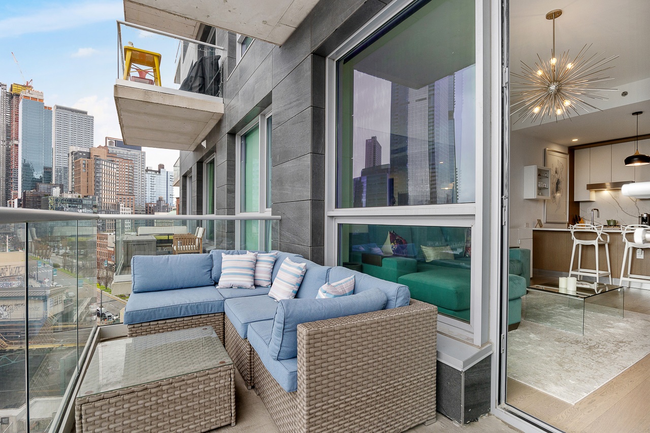 22-43 Jackson Avenue, Unit 8D Queens, NY 11101 - Photo 13 of 16 a outdoor living and dining area with a couch