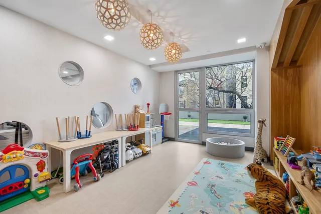 a living room with lots of furniture and a large window