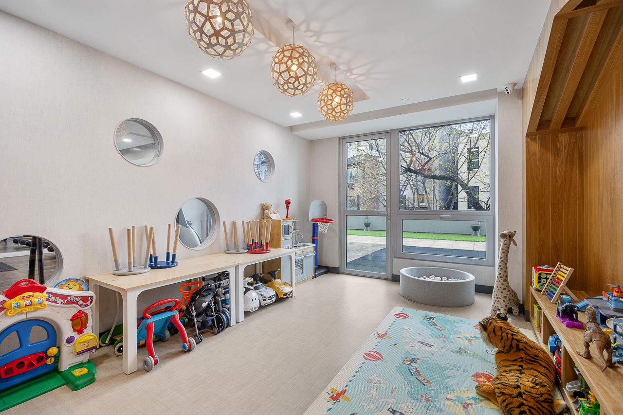 22-43 Jackson Avenue, Unit 8D Queens, NY 11101 - Photo 15 of 16 a living room with lots of furniture and a large window