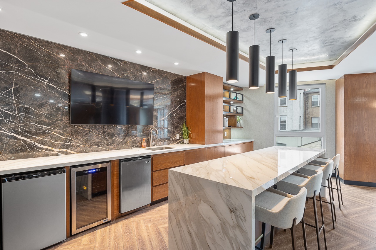 22-43 Jackson Avenue, Unit 8D Queens, NY 11101 - Photo 16 of 16 a kitchen with stainless steel appliances kitchen island granite countertop a table chairs in it and wooden floors