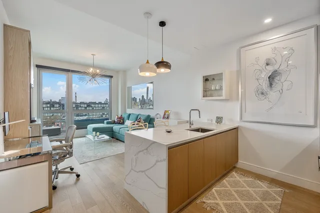 a view of kitchen island a sink and a refrigerator