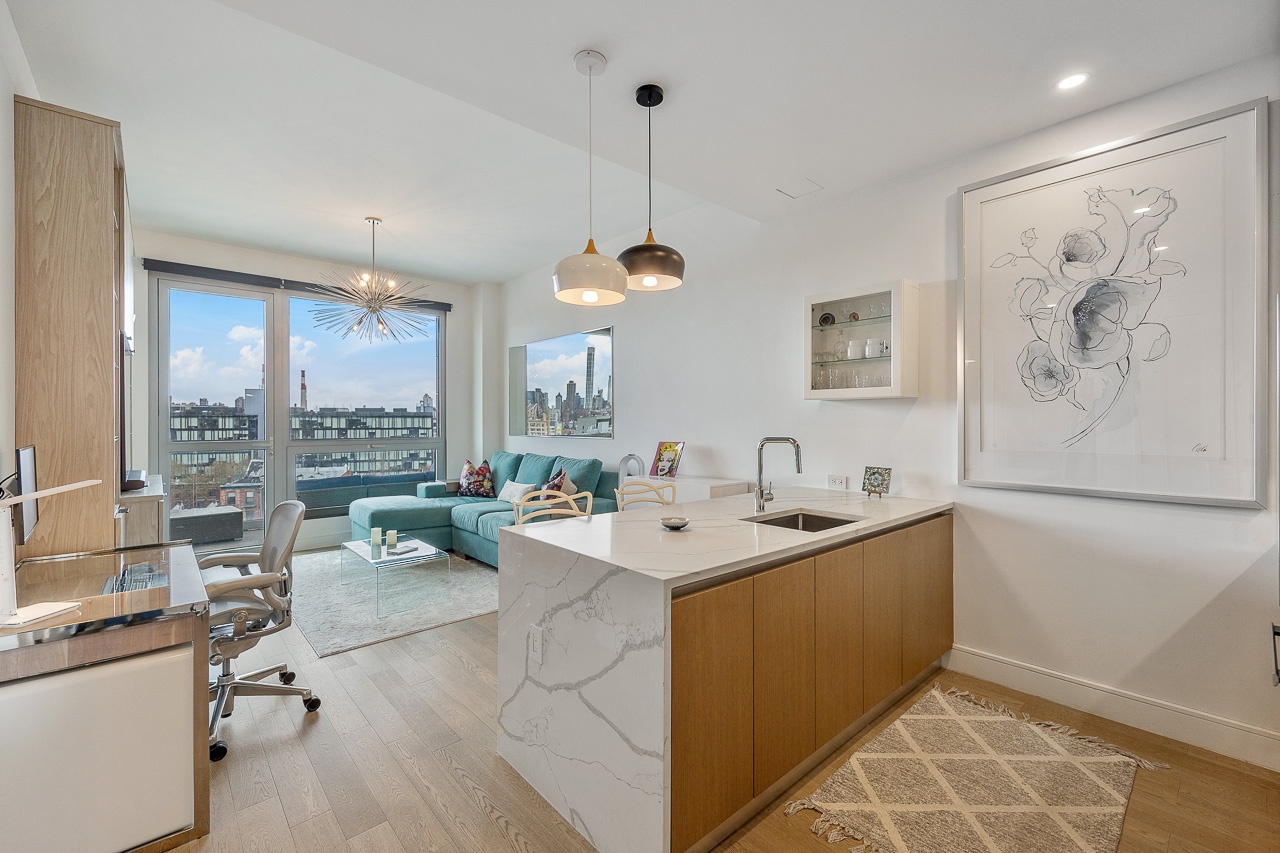 22-43 Jackson Avenue, Unit 8D Queens, NY 11101 - Photo 2 of 16 a view of kitchen island a sink and a refrigerator