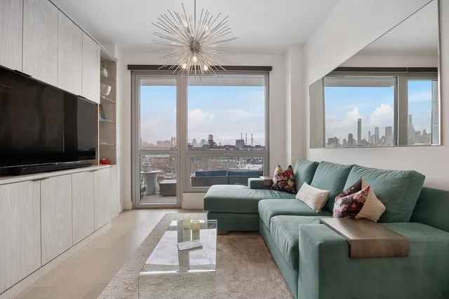 a living room with furniture a flat screen tv and a large window