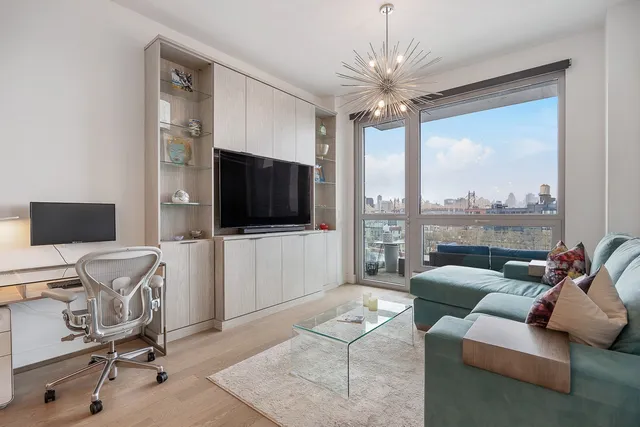 a living room with furniture a flat screen tv and a large window