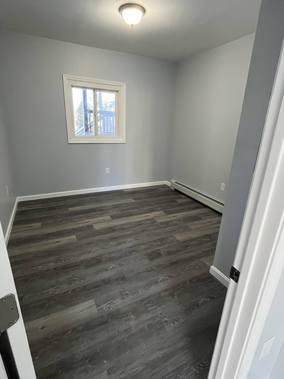 106 Kilburn Street, Unit 2S Fall River, MA 02724 - Photo 4 of 5 wooden floor in an empty room with a window