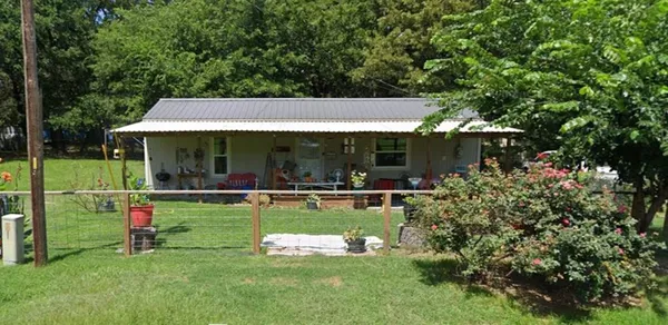 a view of a house with backyard porch and sitting area