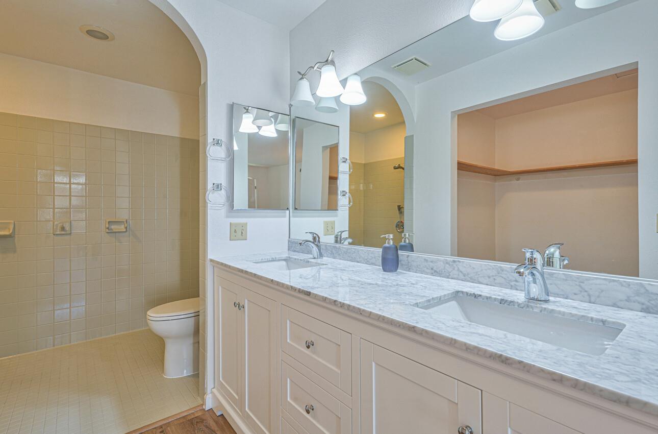 3850 Rio Road, Unit 51 Carmel, CA 93923 - Photo 13 of 24 a bathroom with a granite countertop sink toilet and shower