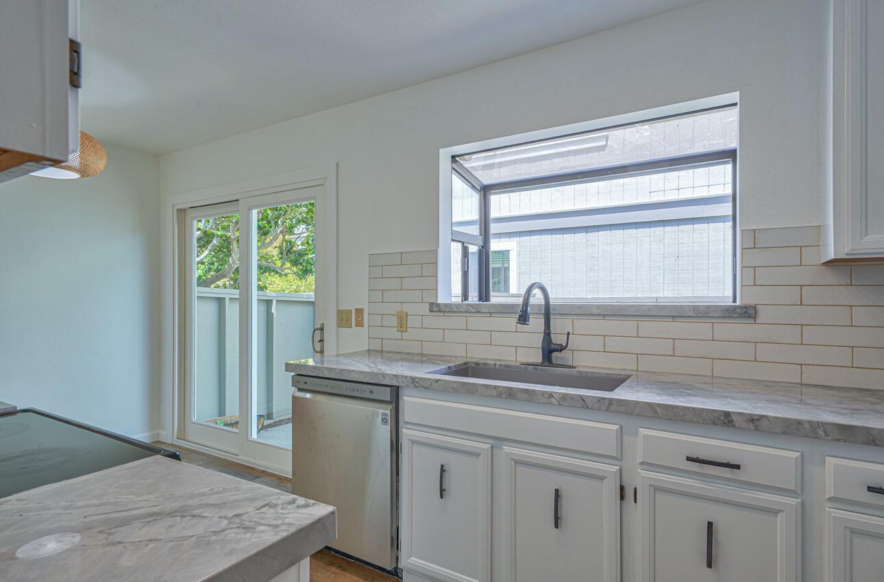 3850 Rio Road, Unit 51 Carmel, CA 93923 - Photo 2 of 24 a kitchen with stainless steel appliances granite countertop a sink and a window