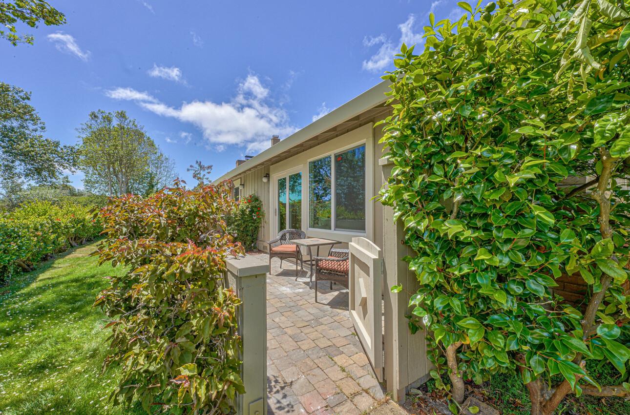 3850 Rio Road, Unit 51 Carmel, CA 93923 - Photo 23 of 24 a view of a patio with table and chairs and potted plants