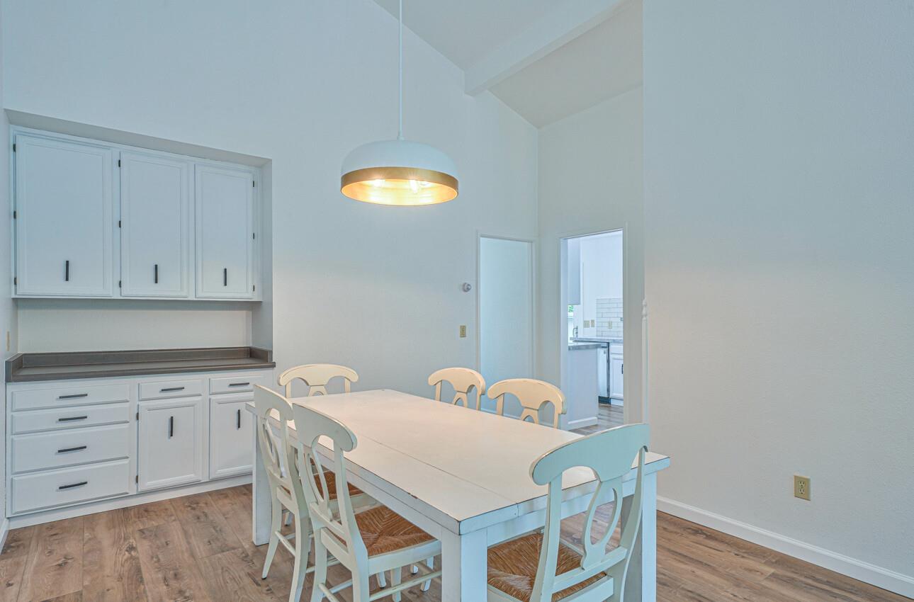 3850 Rio Road, Unit 51 Carmel, CA 93923 - Photo 5 of 24 a view of a kitchen with a table and chairs