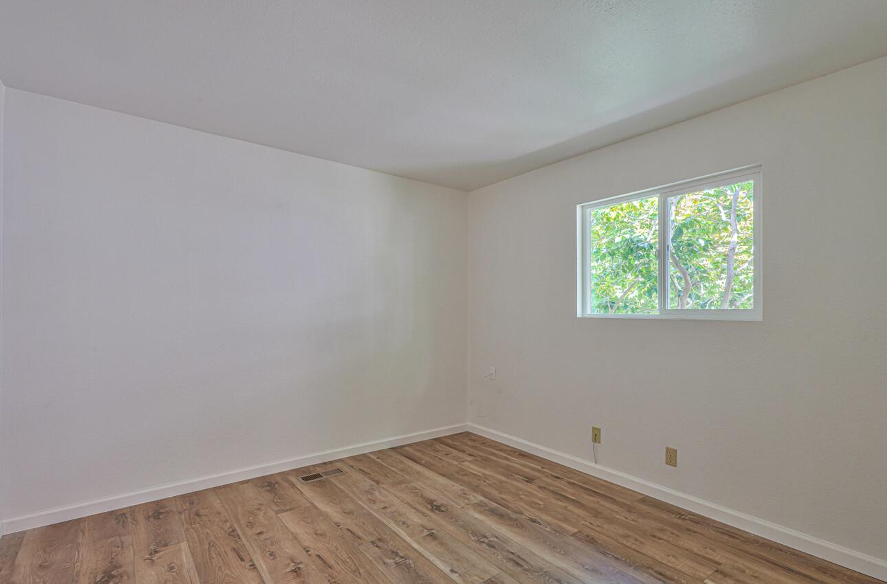 3850 Rio Road, Unit 51 Carmel, CA 93923 - Photo 10 of 24 wooden floor in an empty room with a window