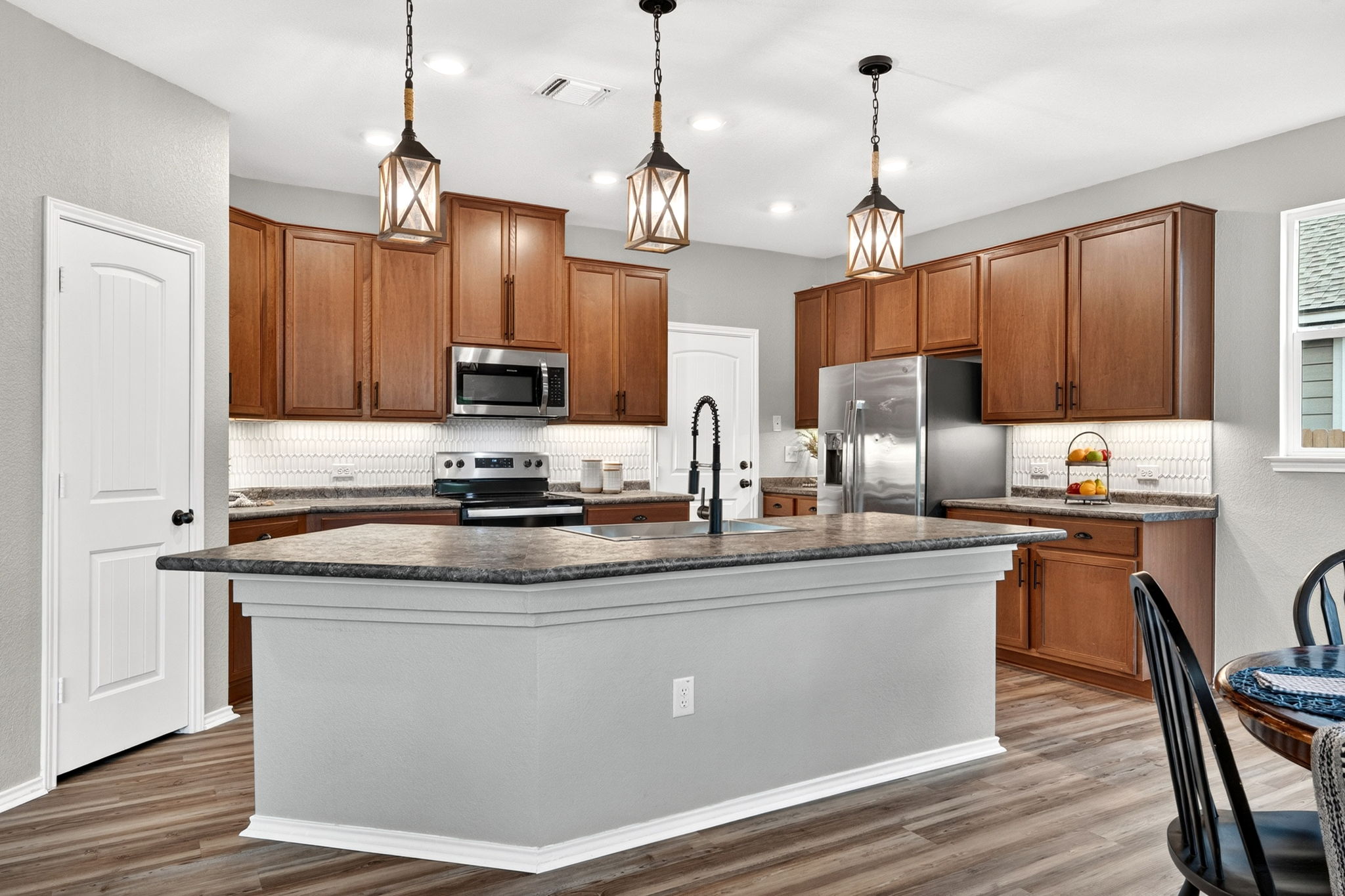 326 Linden Street Bastrop, TX 78602 - Photo 4 of 39 Large kitchen island with a deep single-bowl sink. Beautiful tile backsplash and stainless steel appliances.