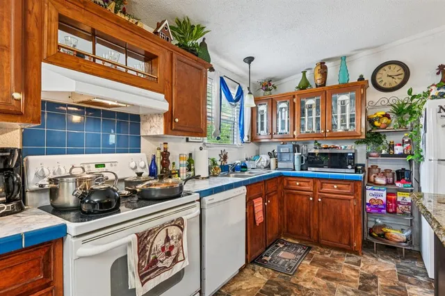 a kitchen with lots of clutter and cabinets