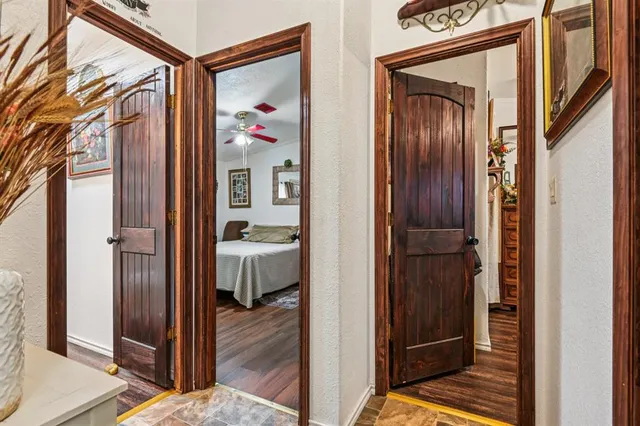 a view of a hallway with wooden floor and closet