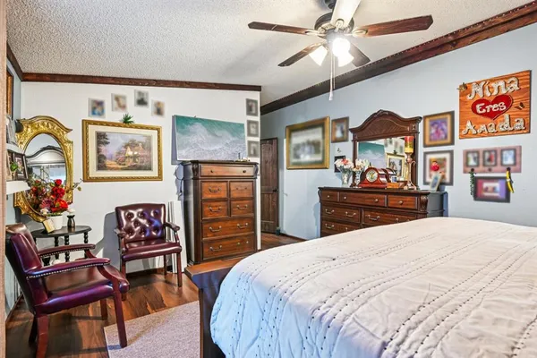 a bedroom with a bed and a dresser in it