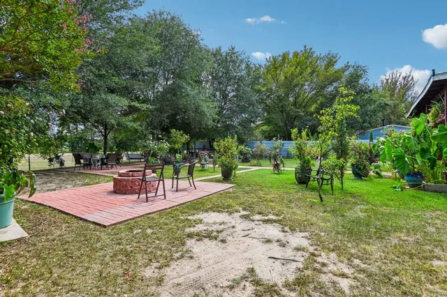 a view of a backyard with sitting area