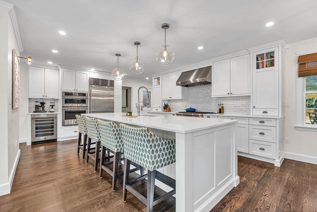 26 Edmunds Road Wellesley, MA 02481 - Photo 5 of 37 a kitchen with stainless steel appliances kitchen island granite countertop a refrigerator a stove and a cabinets with wooden floor