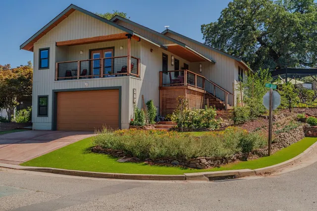 a bedroom with a bed a chandelier and a window