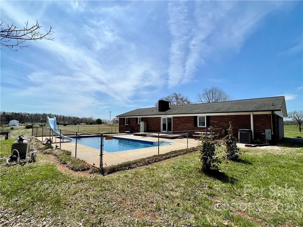 2122 Huckleberry Ridge Road Hiddenite, NC 28636 - Photo 10 of 40 a view of a house with pool and chairs