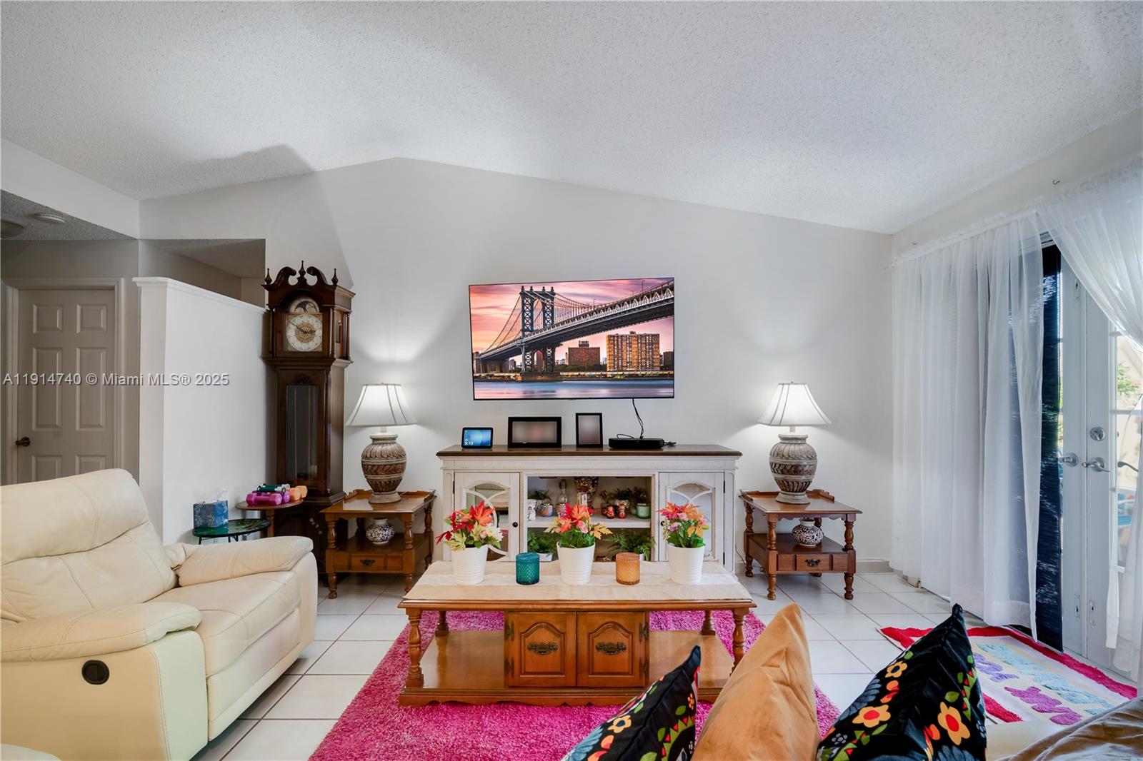13249 Southwest 86th Lane Miami, FL 33183 - Photo 11 of 39 a living room with furniture a rug and a flat screen tv