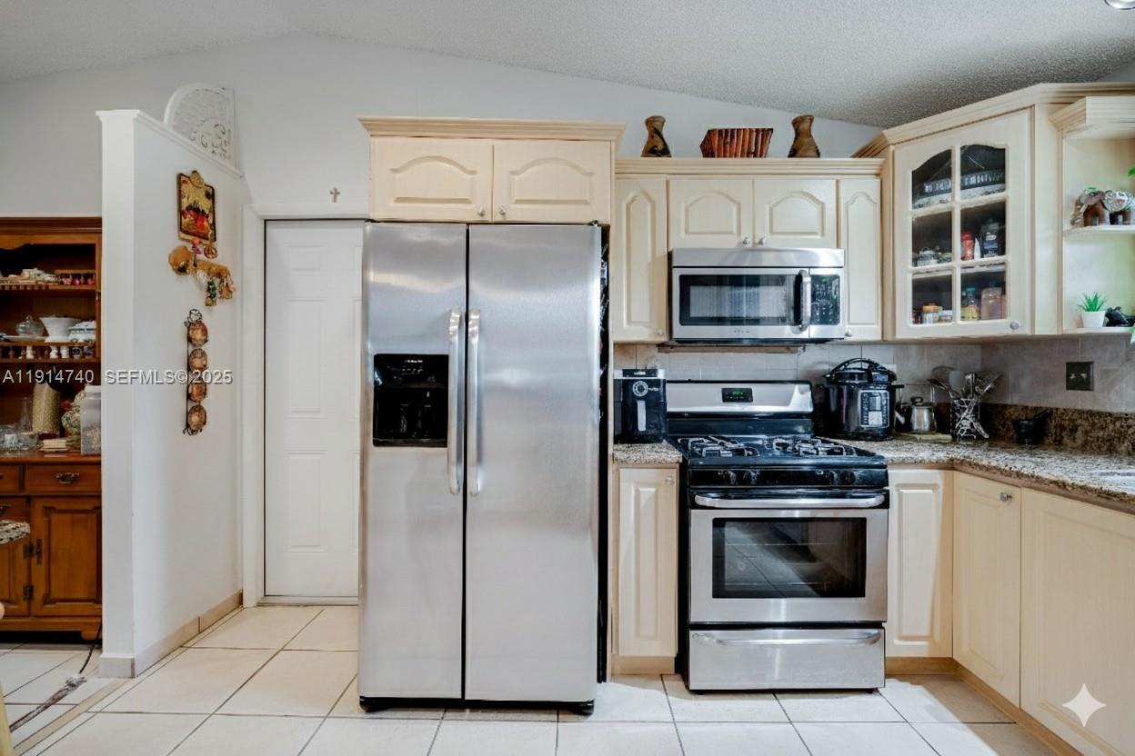 13249 Southwest 86th Lane Miami, FL 33183 - Photo 14 of 39 a kitchen with stainless steel appliances granite countertop a refrigerator and a stove