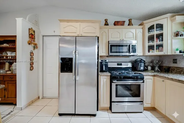 a kitchen with stainless steel appliances granite countertop a sink and cabinets