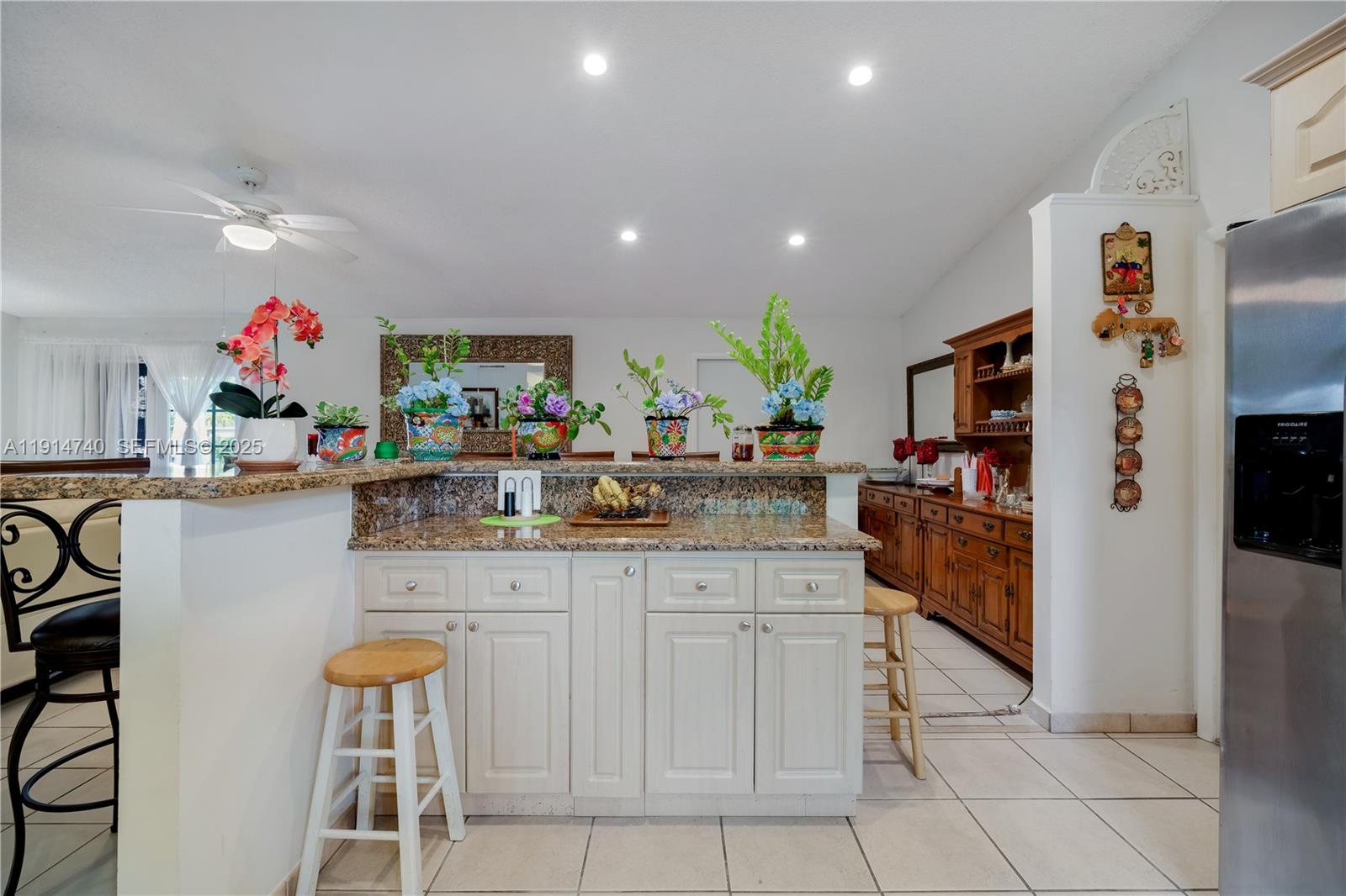 13249 Southwest 86th Lane Miami, FL 33183 - Photo 16 of 39 a kitchen with granite countertop a refrigerator and a sink
