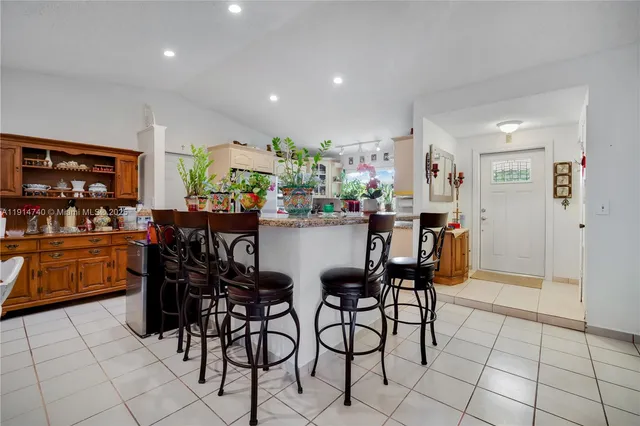 a view of a dining room with furniture and a potted plant