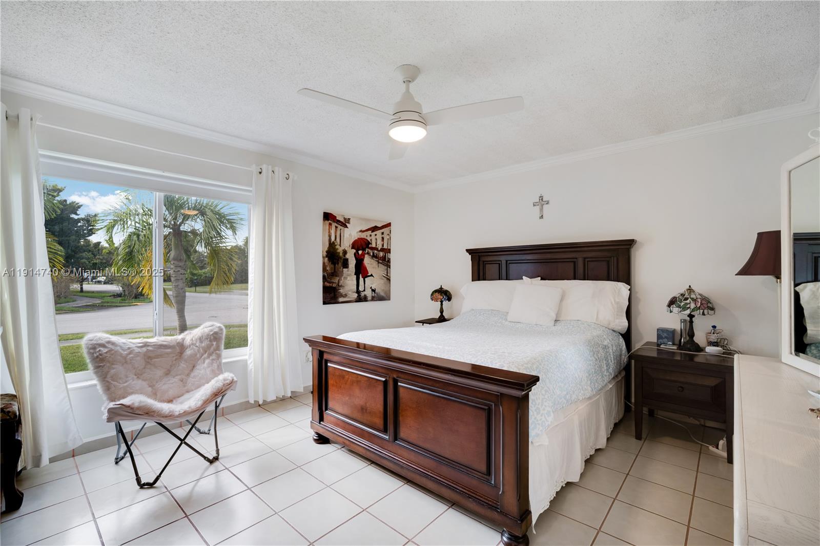 13249 Southwest 86th Lane Miami, FL 33183 - Photo 20 of 39 a bedroom with a bed and a chair