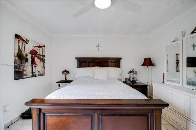 a bedroom with a bed and a potted plant