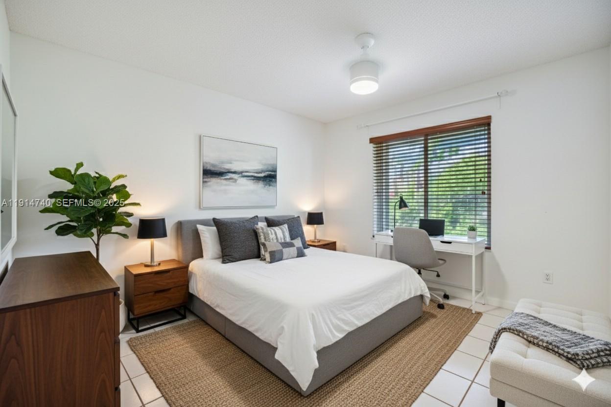13249 Southwest 86th Lane Miami, FL 33183 - Photo 22 of 39 a bedroom with a bed and a potted plant
