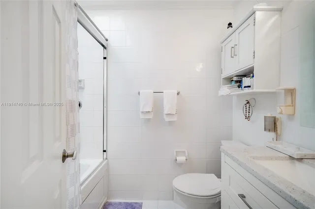 a bathroom with a toilet a sink and a shower