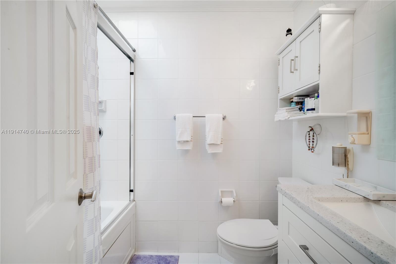 13249 Southwest 86th Lane Miami, FL 33183 - Photo 24 of 39 a bathroom with a sink a toilet and shower