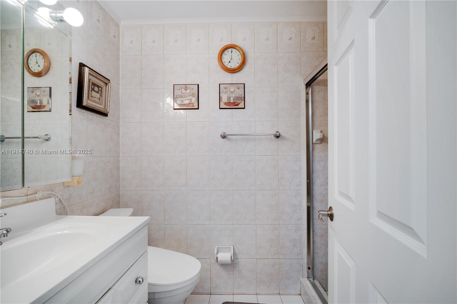 13249 Southwest 86th Lane Miami, FL 33183 - Photo 25 of 39 a bathroom with a toilet a sink and a shower