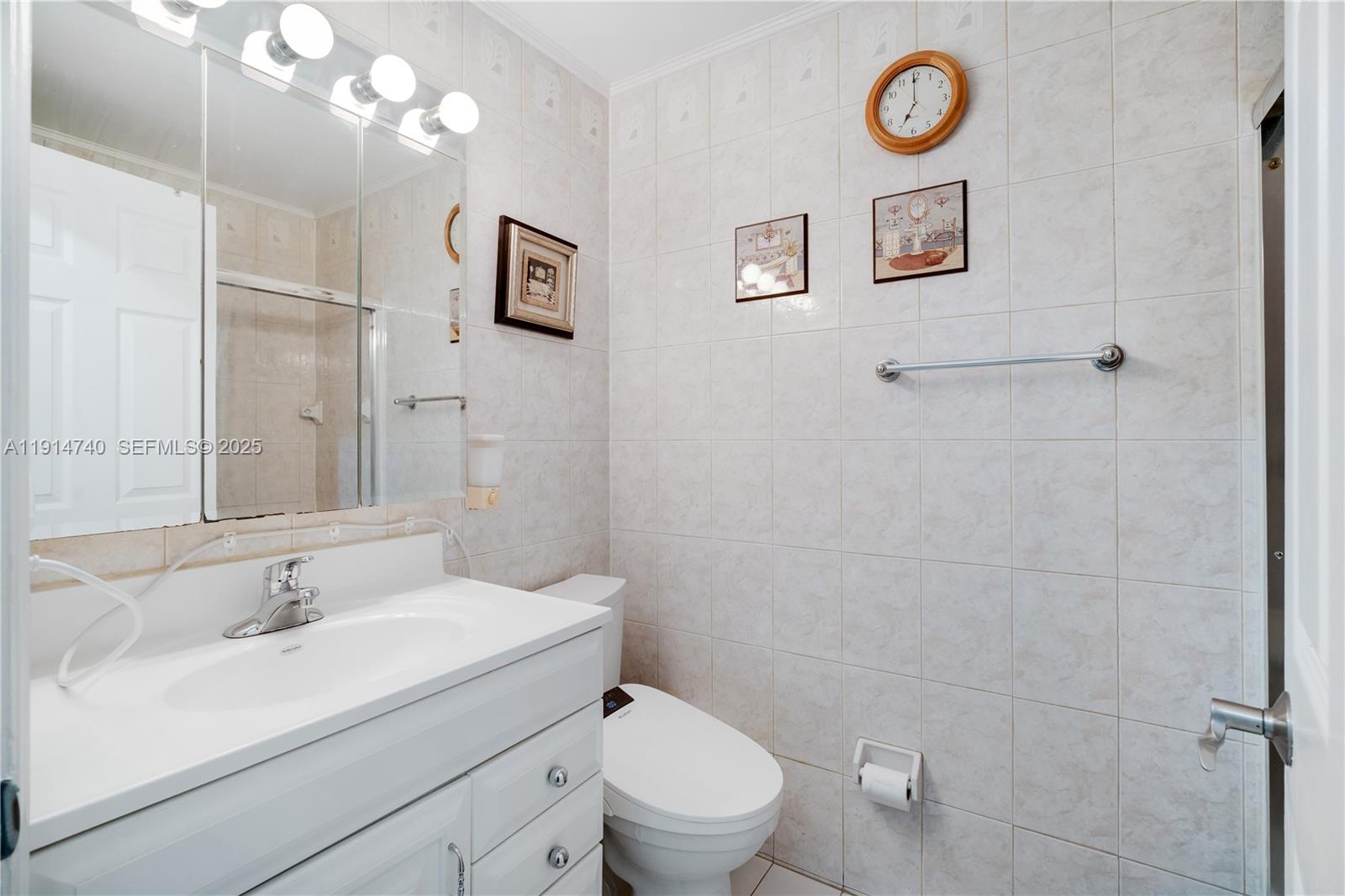 13249 Southwest 86th Lane Miami, FL 33183 - Photo 26 of 39 a bathroom with a toilet sink and mirror