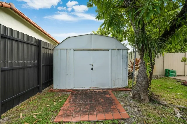 a view of a house with backyard and sitting area