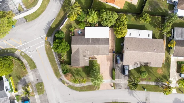 an aerial view of a house with a yard
