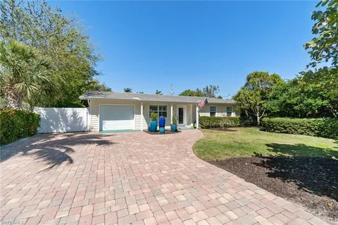 a view of a house with a yard and a garage