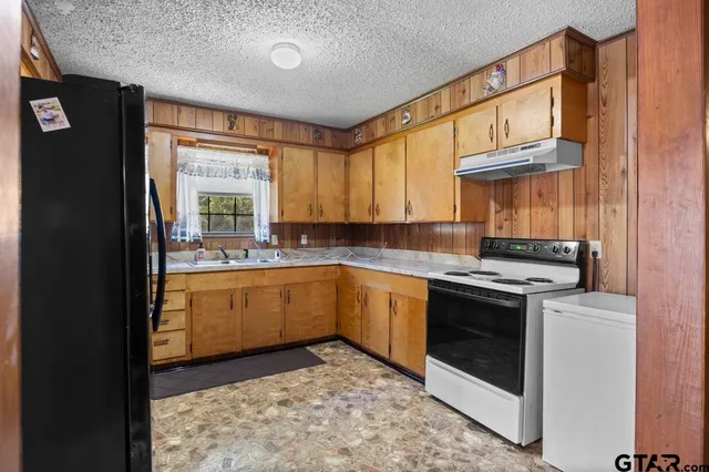 a kitchen with a stove top oven sink and cabinets