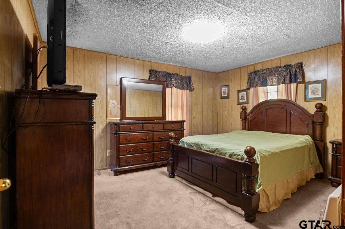 807 High Street Marshall, TX 75670 - Photo 17 of 33 a bedroom with a bed and a flat tv screen on dresser