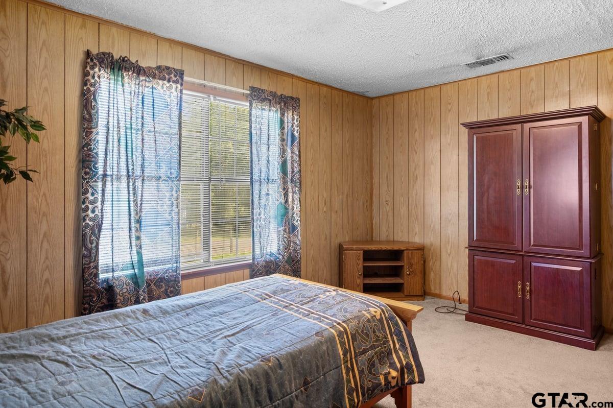 807 High Street Marshall, TX 75670 - Photo 19 of 33 a bedroom with a bed and a dresser