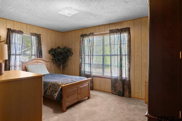 a spacious bedroom with a large bed and a large window
