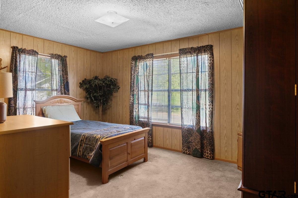 807 High Street Marshall, TX 75670 - Photo 20 of 33 a spacious bedroom with a large bed and a large window