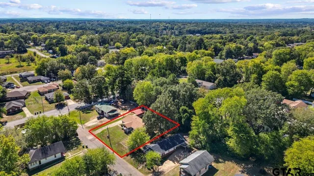 an aerial view of a house with a yard