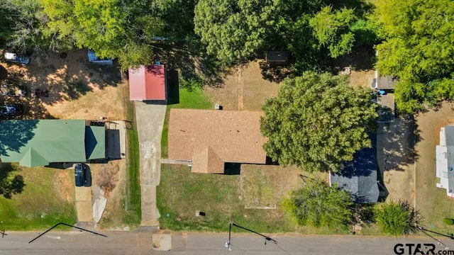 an aerial view of residential houses with outdoor space and street view
